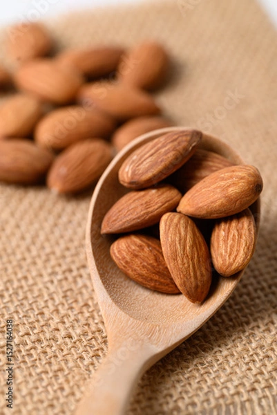 Obraz Raw almond nut seed in wooden spoon, Food ingredient