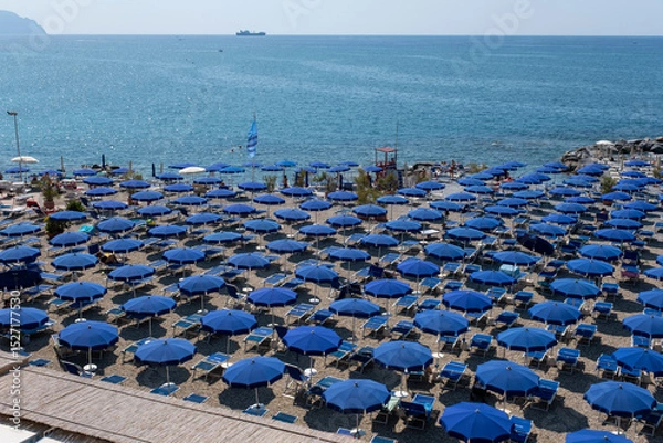 Obraz Beach with blue umbrellas on the coast of Genoa, Italy