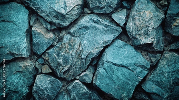 Fototapeta Close-Up of Textured Blue Rocks Arranged in a Natural Pattern. Blue-textured stones form a close-up view showcasing natural textures and rugged patterns.