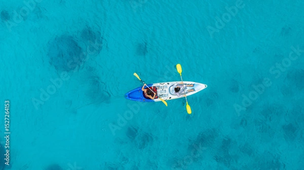 Fototapeta Aerial view of a kayak in the blue sea .man kayaking he does water sports activities