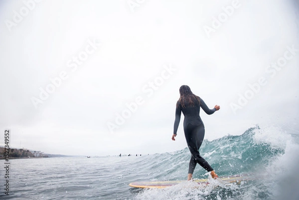 Obraz Girl surfing waves