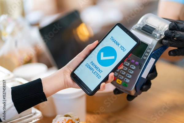 Fototapeta Woman Using Mobile Phone Payment to Transfer Money to bakery Shop Seller.NFC QR code device,payWave,contactless payment code for fast digital transaction,Online banking app on mobile phone,paperless