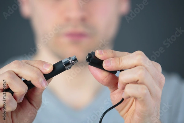 Fototapeta administrator holding network cables connected to servers