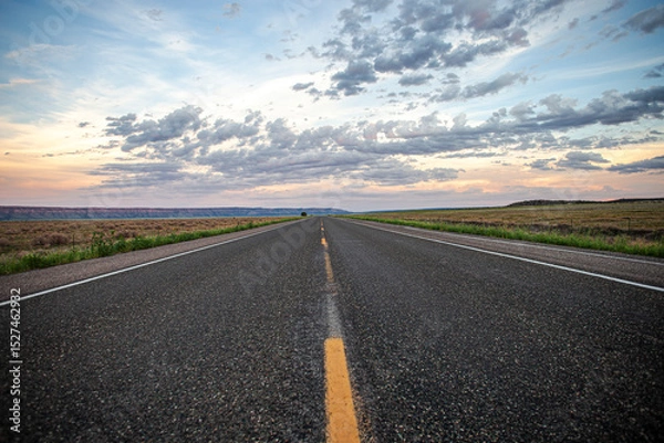 Fototapeta Open road low angle asphalt cloudy sky