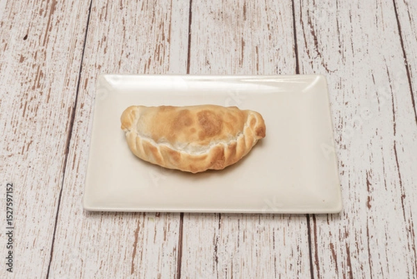 Fototapeta This incredible adaptation and regionalization turned the empanada into one of Latin America's most iconic and beloved dishes,