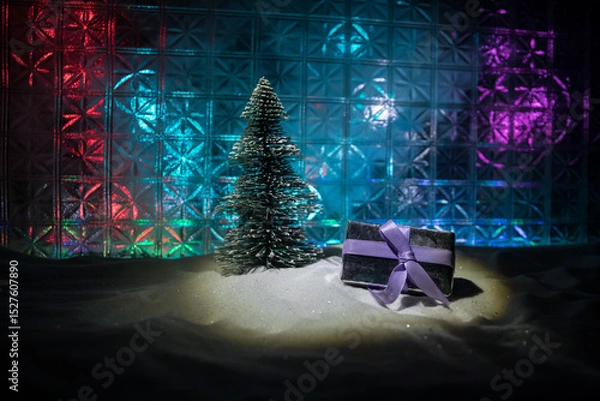 Fototapeta Christmas home decoration with snow and tree on a dark background with copy space. Selective focus. New Year attributes on background