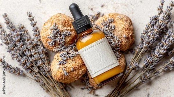 Obraz Essential oil bottle with blank label surrounded by dried lavender flowers and bath bombs