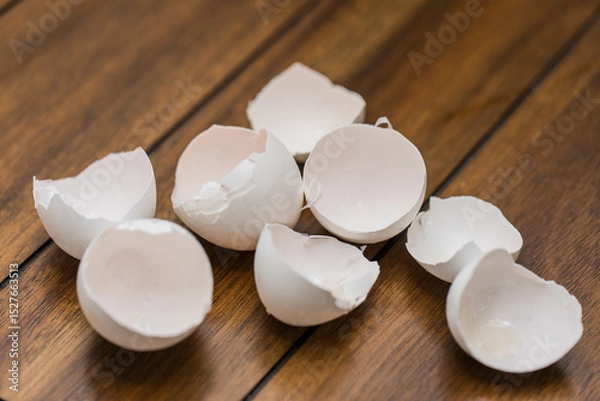 Fototapeta broken egg shells on wooden background