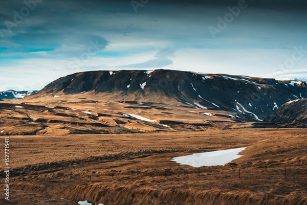 Fototapeta Barren rugged mountain with blue sky in remote wilderness at Iceland