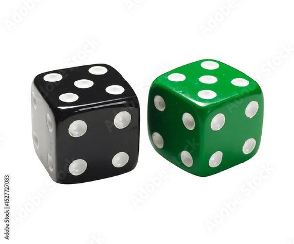 Fototapeta A close up shot of a black die and a green die with white dots on a black background in a studio shot isolated white background