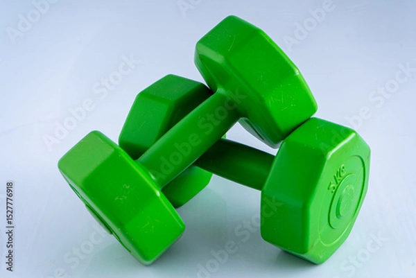Fototapeta Two dumbbells 2 kg each. Sports equipment. White background. Green set exercise