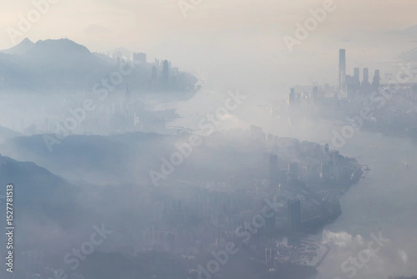Fototapeta Aerial view from a Cathay Pacific plane over the various Islands of Hong Kong and the financial district with many high-rise skyscrapers creating a dense country