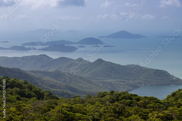Fototapeta Lantau Island, Hong Kong, 10-20-2024 Views over Lantau Island seen from the cable car which connects downtown Tung Chung and Ngong Ping with the statue of the biggest buddha and the Po Lin Monastery