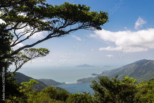 Fototapeta Lantau Island, Hong Kong, 10-20-2024 Views over Lantau Island seen from the cable car which connects downtown Tung Chung and Ngong Ping with the statue of the biggest buddha and the Po Lin Monastery