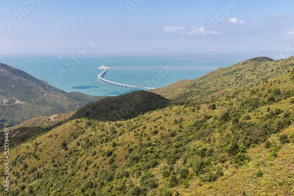 Fototapeta Lantau Island, Hong Kong, 10-20-2024 Views over Lantau Island seen from the cable car which connects downtown Tung Chung and Ngong Ping with the statue of the biggest buddha and the Po Lin Monastery