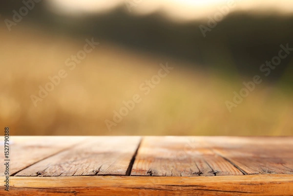 Fototapeta Empty rustic table in front of countryside background. product display and picnic concept