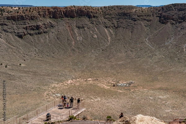 Obraz Meteor Crater's rugged terrain in Winslow, Arizona. Steep cliffs and rocky slopes highlight the crater's geological features.