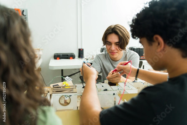Obraz Group of high school students working on electronics project
