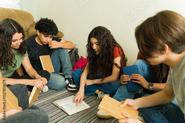 Obraz Group of high school students reading and studying together in book club