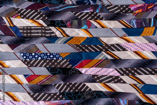 Fototapeta Patchwork quilt Blanket. A fragment of colorful pieces of fabric sewn together.