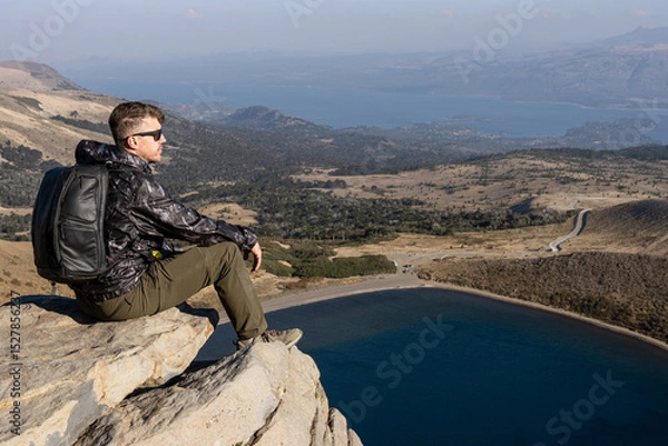 Fototapeta Caucasian Relaxing at Scenic Overlook of Batea Mahuida Viewpoint. Villa Pehuenia, Neuquen, Argentina