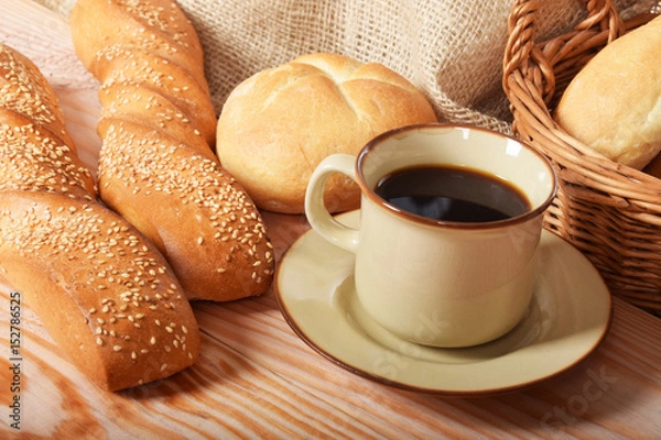 Obraz Fresh baked roll wrapped in parchment paper