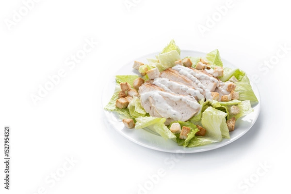 Fototapeta Crunchy Caesar salad with chicken isolated on white background. Copy space