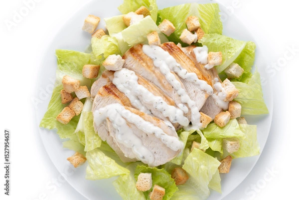 Fototapeta Crunchy Caesar salad with chicken isolated on white background