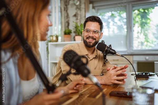 Obraz man and woman host and guest in podcast at home studio