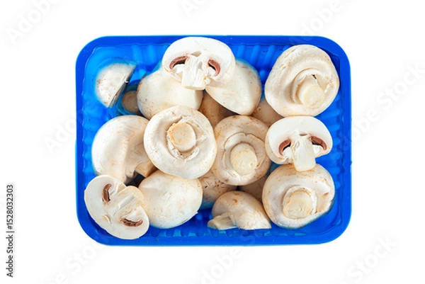 Fototapeta Whole and sliced ​​champignons in a container isolated on white background.