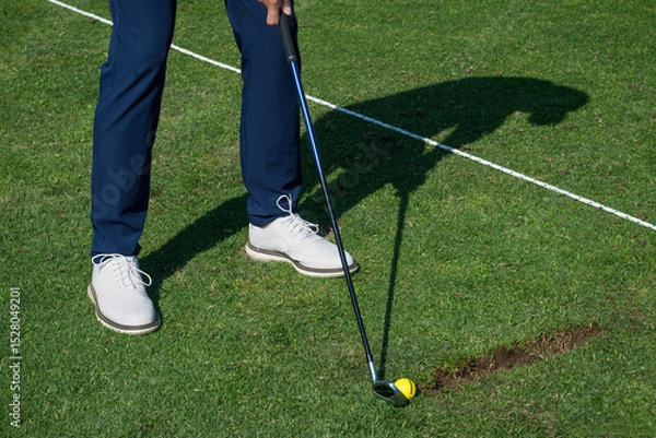 Fototapeta Golfer preparing to swing at the driving range