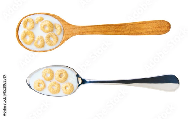 Fototapeta Whole grain cereal rings with milk in a metal spoon isolated on white background, top view.
