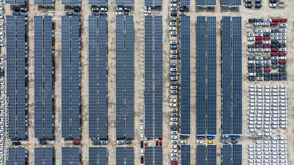 Fototapeta Aerial top view of car park with solar panel photovoltaic, Solar panel photovoltaic installation on roof of car parking lot, Alternative electricity source sustainable resources.
