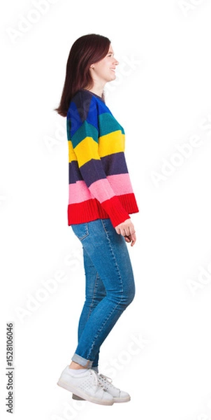 Fototapeta Side view full length portrait of casual young woman walking and smiling isolated on transparent background