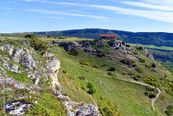 Fototapeta A hiker climbs to the Hermitage of San Lorenzo in the Valderejo Natural Park, Basque Country,