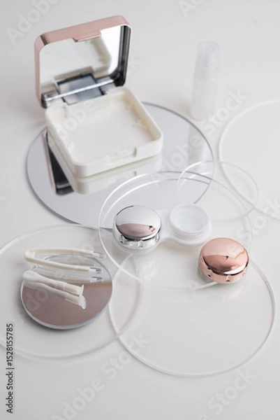 Fototapeta Contact lenses, case and bottle with solution and eye drops on white background. Eye health and care, vision, ophthalmology concept, close-up 