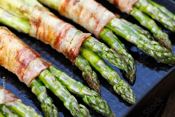 Obraz Grilled green asparagus wrapped bacon, close up view