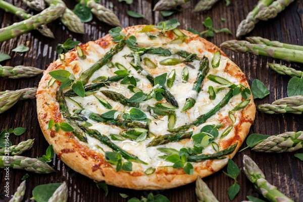 Obraz Green asparagus pizza sprinkled with fresh herbs, close-up view