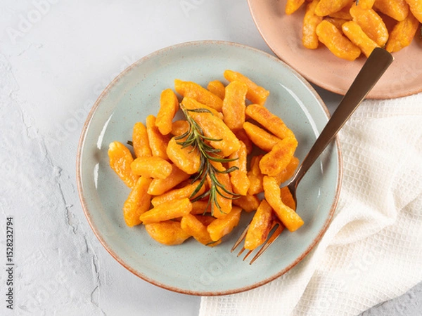 Fototapeta Pumpkin recipe homemade gnocchi on pastel color background