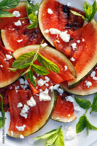 Obraz Close-up view of a fruit salad with grilled watermelon, feta cheese and fresh mint leaves