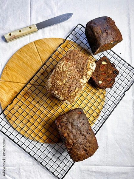 Fototapeta Flat lay on white background of healthy homemade bread served on table.