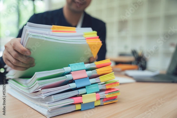 Obraz Businessman Handling Stack of Documents
