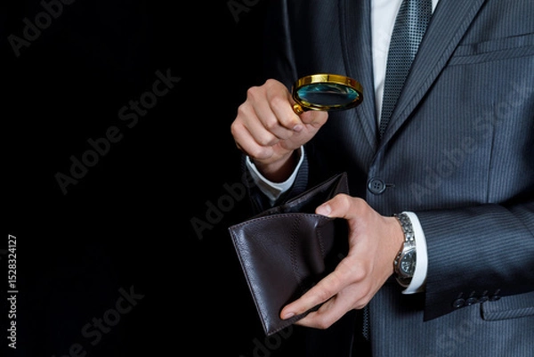 Fototapeta Inspecting a wallet with a magnifying glass