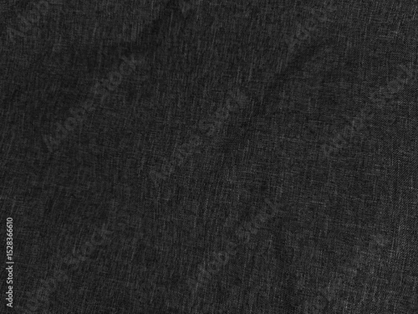 Fototapeta Dark textured fabric with visible weave pattern, creating an uneven surface. The appearance is matte and slightly wrinkled, suggesting soft material with a subtle shadow effect