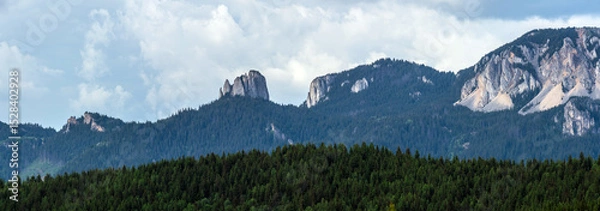 Fototapeta Panoramic view of Egyeskő (Lonely Rock) in Romania’s Hagymás Nature Reserve, with the rockfall known as "Devil’s Mill." High-resolution summer scene with dramatic clouds and rich natural detail.