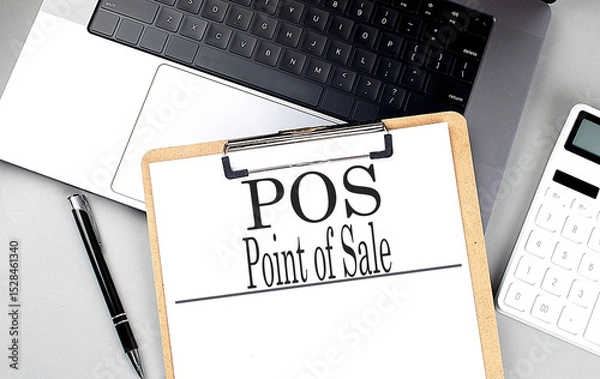 Fototapeta POS point of sale text on clipboard with laptop, pen and calculator on gray background