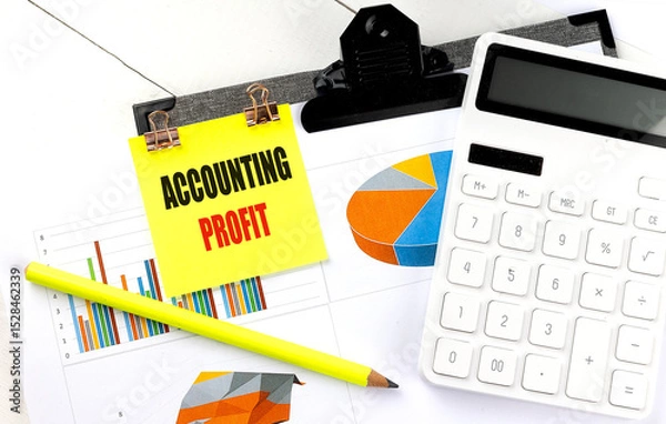 Fototapeta Accounting profit note on clipboard with financial charts, calculator and pencil on white office desk