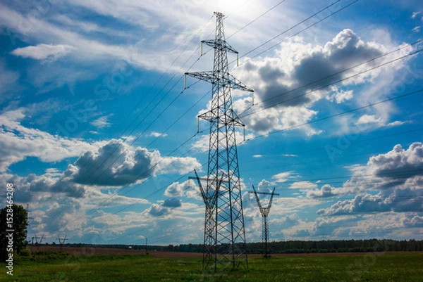 Fototapeta High voltage power line with supports against clouds