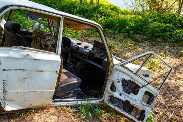 Fototapeta Abandoned and mangled body of a Russian-made car