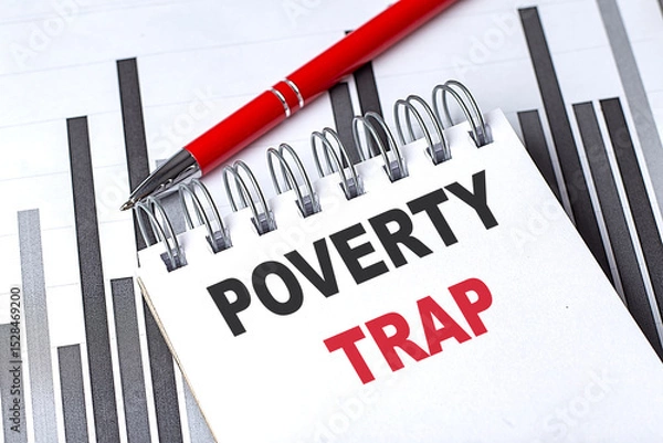 Fototapeta Poverty trap text on spiral notebook with red pen and bar chart background